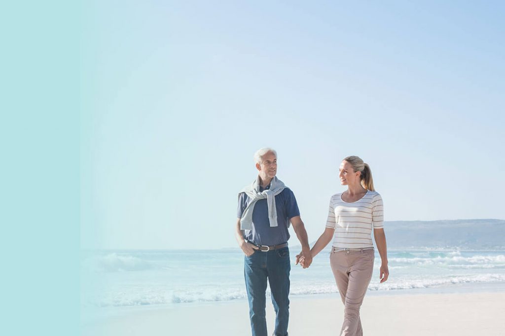 couple walking down the beach holding hands