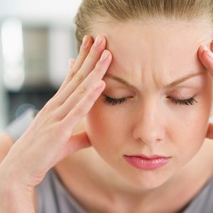 person with their hands on their head